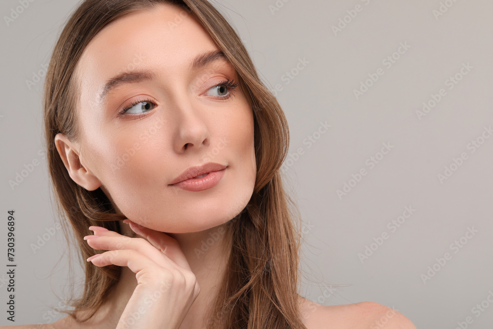Beautiful woman with healthy skin on gray background, space for text Beautiful woman with healthy skin on gray background, space for text