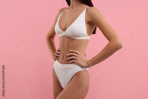 Young woman in stylish white bikini on pink background, closeup