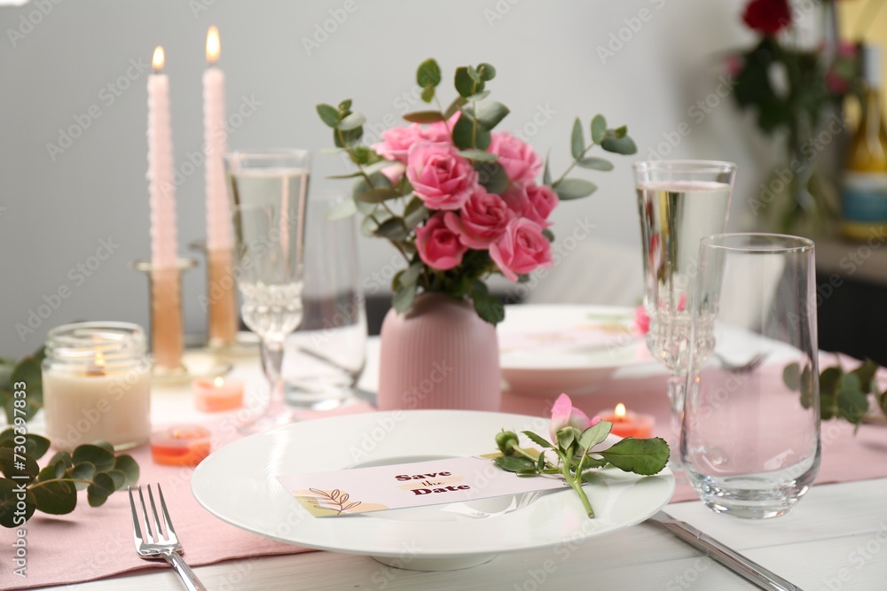 Romantic table setting with flowers and candles Romantic table setting with flowers and candles