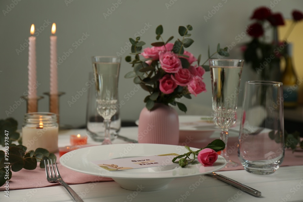 Romantic table setting with flowers and candles Romantic table setting with flowers and candles