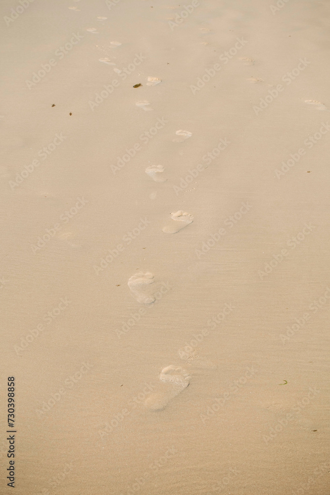 Footprints fading away on pristine beach sand Footprints fading away on pristine beach sand