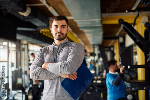 Portrait of professional fitness coach in gym looking at camera.