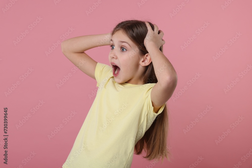Portrait of surprised girl on pink background Portrait of surprised girl on pink background