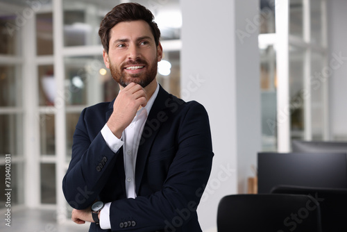 Portrait of smiling man in office, space for text. Lawyer, businessman, accountant or manager