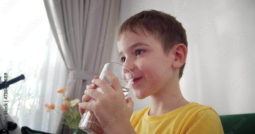 Handsome little boy child mineral water. healthy eating child eating breakfast kid. Child little boy in kitchen drinks yogurt milk and licks her lips. Happy kid smiling kefir having breakfast. 4K Handsome little boy child mineral water. healthy eating child eating breakfast kid. Child little boy in kitchen drinks yogurt milk and licks her lips. Happy kid smiling kefir having breakfast. 4K