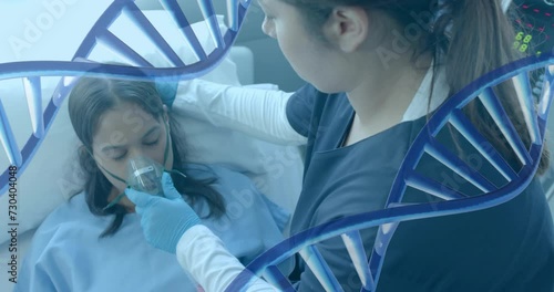 Animation of dna strands over diverse female doctor and patient with oxygen mask in hospital photo