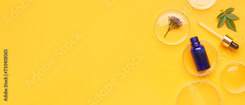 Petri dishes with samples and bottle of cosmetic product on yellow background with space for text
