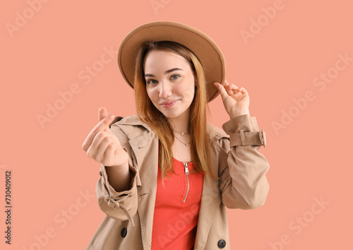 Young woman making heart wi...