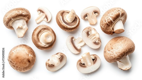 Set of fresh whole and sliced champignon mushrooms isolated on white background. Top view