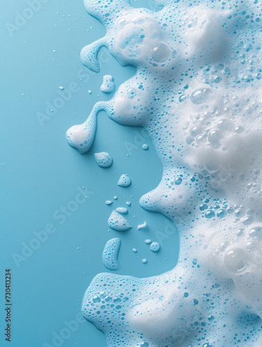 splash of foam from soap or shampoo on blue background