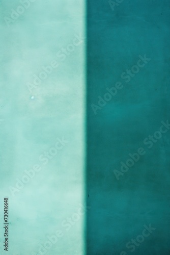 Turquoise wall with shadows on it