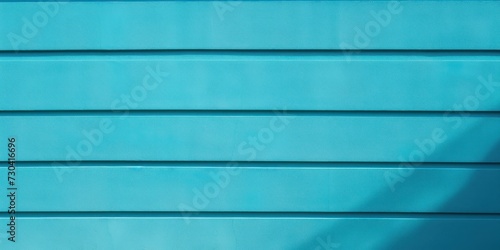 Turquoise wall with shadows on it