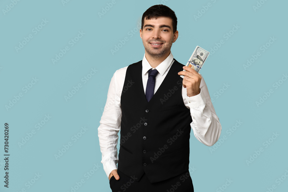 Young businessman with bribe on blue background Young businessman with bribe on blue background