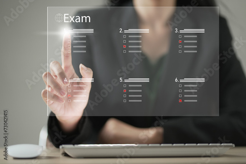 student passing online exam concept. Virtual test or questionnaire show on screen and answer check mark to measure grades. Education futuristic technology. Students taking online exams by laptop.