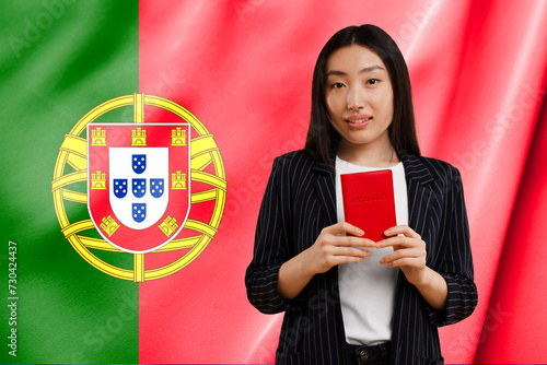 Immigration. Woman with passport against national flag of Portugal, space for text photo