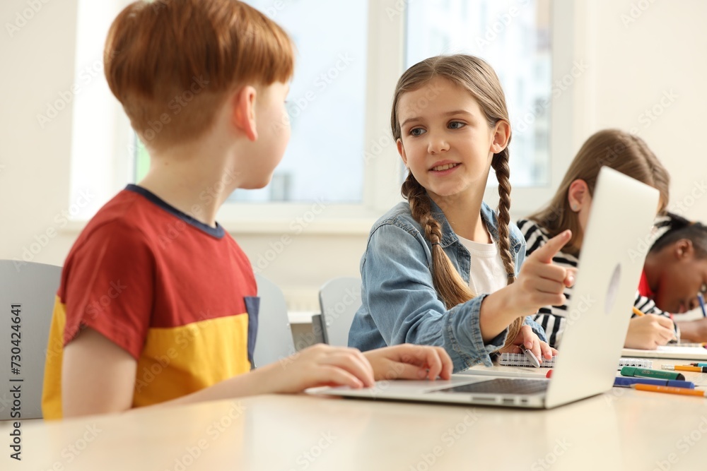 Cute children studying in classroom at school Cute children studying in classroom at school
