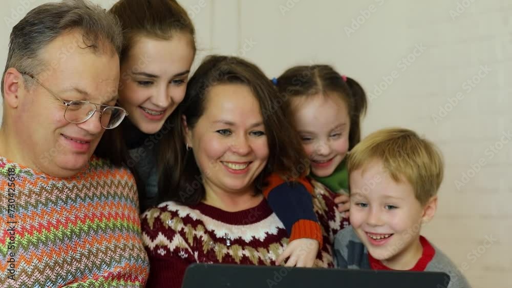 Five people family get fun during watch something on laptop Five people family get fun during watch something on laptop