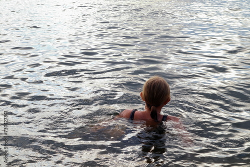 Female swimming at a deep lake. Dark summer water.  © Martin of Sweden