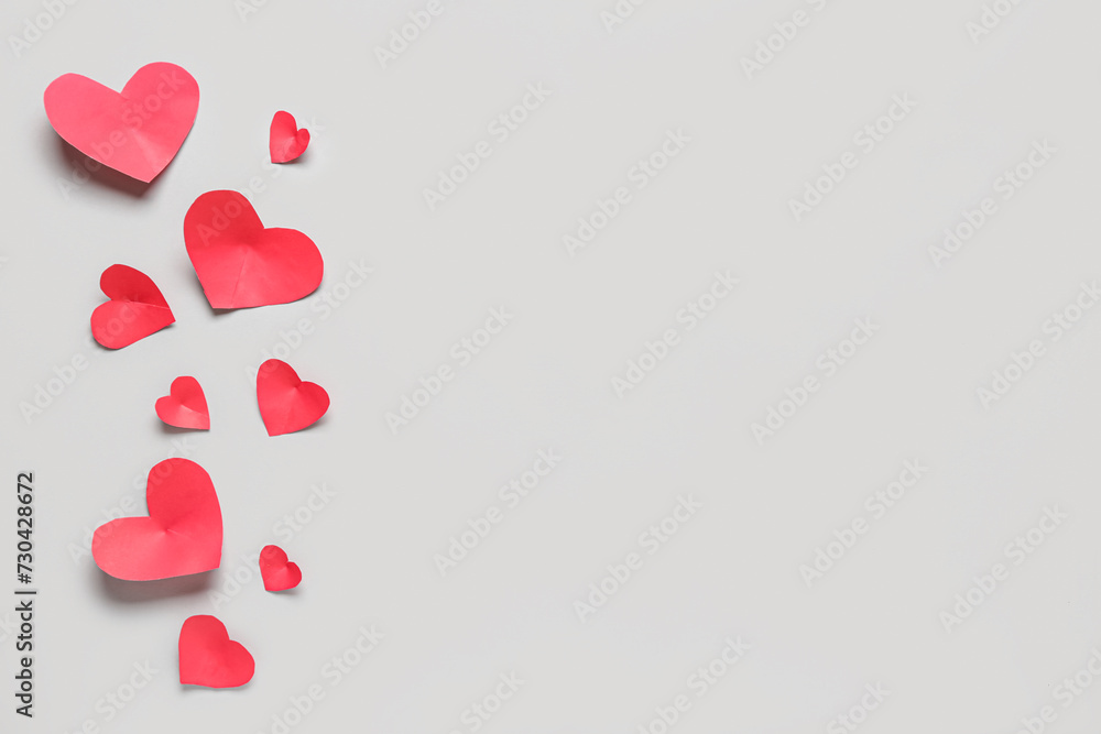 Composition with red paper hearts on grey background. Valentines Day celebration