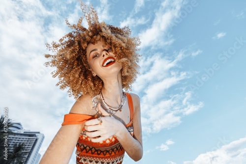 Joyful Beach Traveler: Smiling Woman Dancing with Open Mouth Expressing Freedom and Happiness in a Wide Angle Lens Portrait