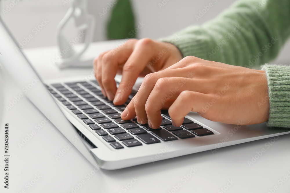 Handsome young man using laptop on online date at home, closeup