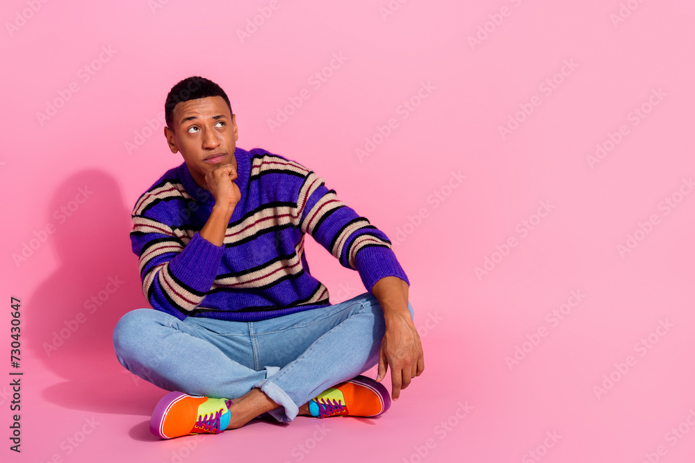 Full length photo of handsome young guy raise eyebrow look empty space wear trendy purple striped garment isolated on pink color background Full length photo of handsome young guy raise eyebrow look empty space wear trendy purple striped garment isolated on pink color background
