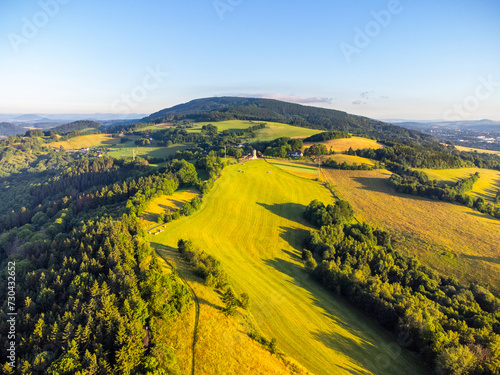 Green hilly landscape with green meadows and forests. Jested ridge near Liberec  Czechia. Aerial view from drone.