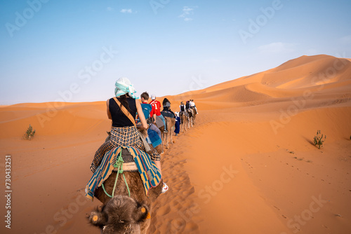girl riding a camel on the dessert
