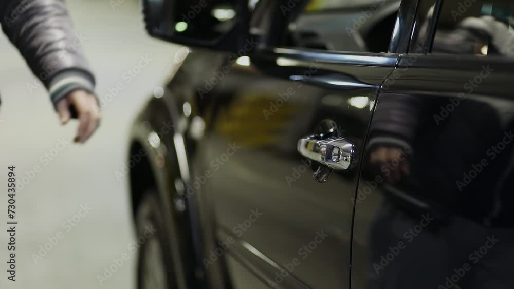 Man comes and opens drivers door of black car. Slow motion Man comes and opens drivers door of black car. Slow motion