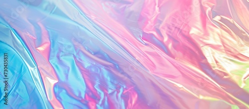 Gradient pastel colors on a holographic background create an abstract, foil fashion aesthetic reminiscent of a rainbow.