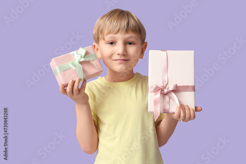 Happy young boy holding two...
