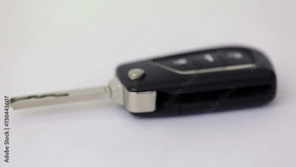 Car key with remote control rotates isolated on white Car key with remote control rotates isolated on white