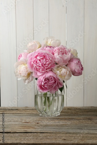 Fototapeta Naklejka Na Ścianę i Meble -  Beautiful peonies in vase on wooden table