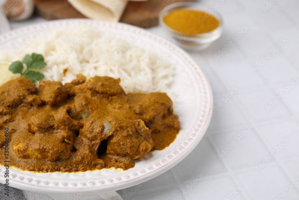 Delicious chicken curry with rice on white tiled table, closeup Delicious chicken curry with rice on white tiled table, closeup
