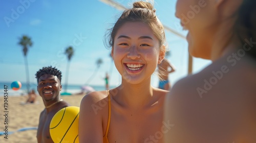 Asian woman playing beach vollyball with friends © Barbara Taylor