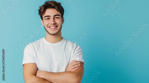 Portrait of handsome smiling young man with folded arms isolated, mockup blank tshirt