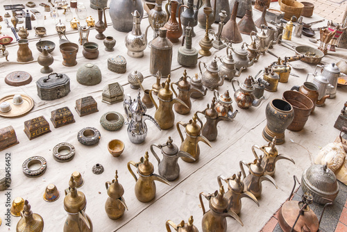 Obraz na płótnie Traditional brass and brass coffee and tea pots at the Souq Al-Zal. w salonie