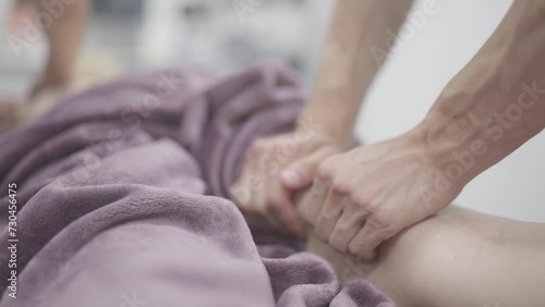 Masseur Providing a Deep Tissue Leg Massage at Spa