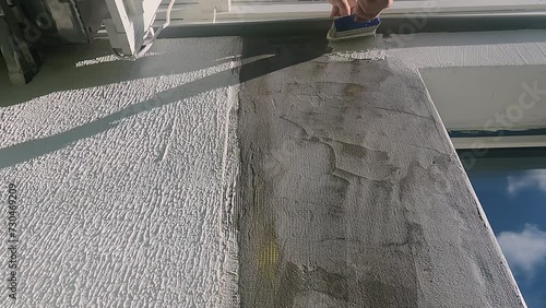 Masterful Renovation: Expertly Applying Cement-Based Hvit Putty to Wall Surface. photo