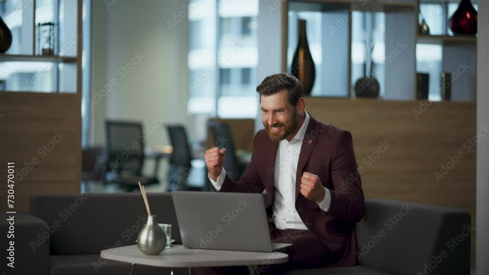 Surprised winner looking computer screen working office. Rich manager rejoicing Surprised winner looking computer screen working office. Rich manager rejoicing