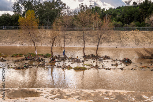 Glendale, CA, USA – February 7, 2024: After days of heavy rain, water flows through the flood control channel in the Glendale Narrows portion of the Los Angeles River in Glendale, CA.