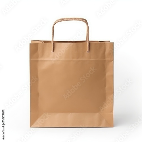 A recycled kraft brown paper shopping bag stands alone against a white background, offering mock-up and copy space.