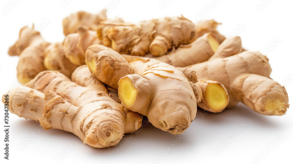 A close-up view of fresh ginger roots, showcasing their intricate textures and warm tones, isolated on a white background.