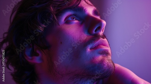 Close-up of a man in a thoughtful pose, in front of a purple studio background generative ai