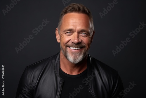 Portrait of a happy mature man in a black leather jacket.