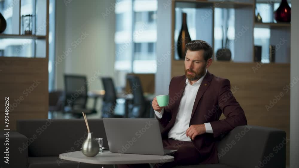 Worried businessman drinking espresso looking computer office. Man feeling tired Worried businessman drinking espresso looking computer office. Man feeling tired