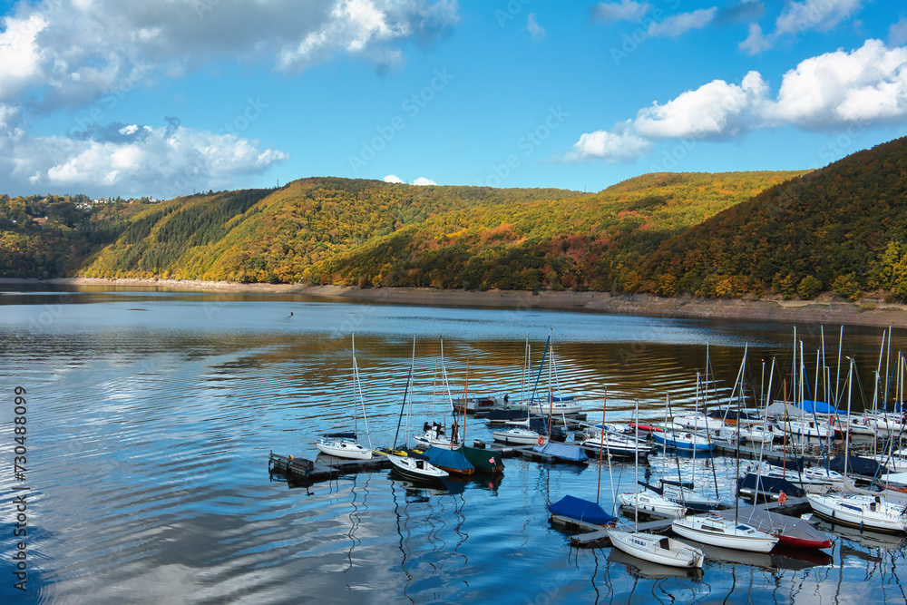 Sailing boats on the sunny Rursee in the North Eifel, Germany