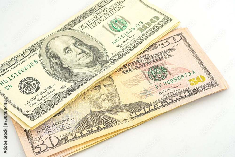 Close up of different dollar bills. Isolated on a white background. 100 and 50 dollar bundles up close on a white background Close up of different dollar bills. Isolated on a white background. 100 and 50 dollar bundles up close on a white background