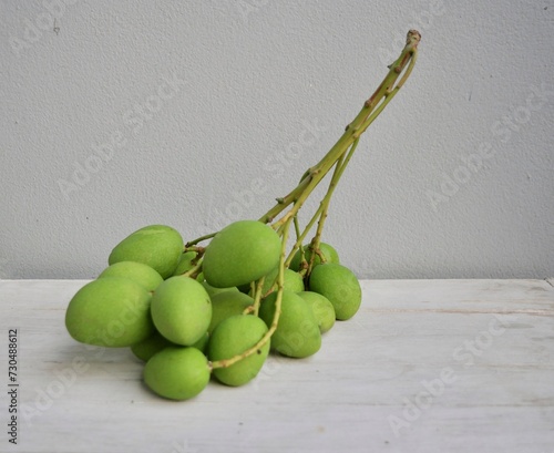 Mangifera caloneura Kurz mango fruit fresh on white background  photo