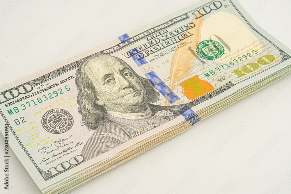 Dollars pack isolated on white background. Several 100 dollar bills are stacked up Dollars pack isolated on white background. Several 100 dollar bills are stacked up